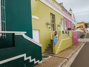 Woman sitting next to stairs in Cape Town's Bo-Kaap neighbourhoud