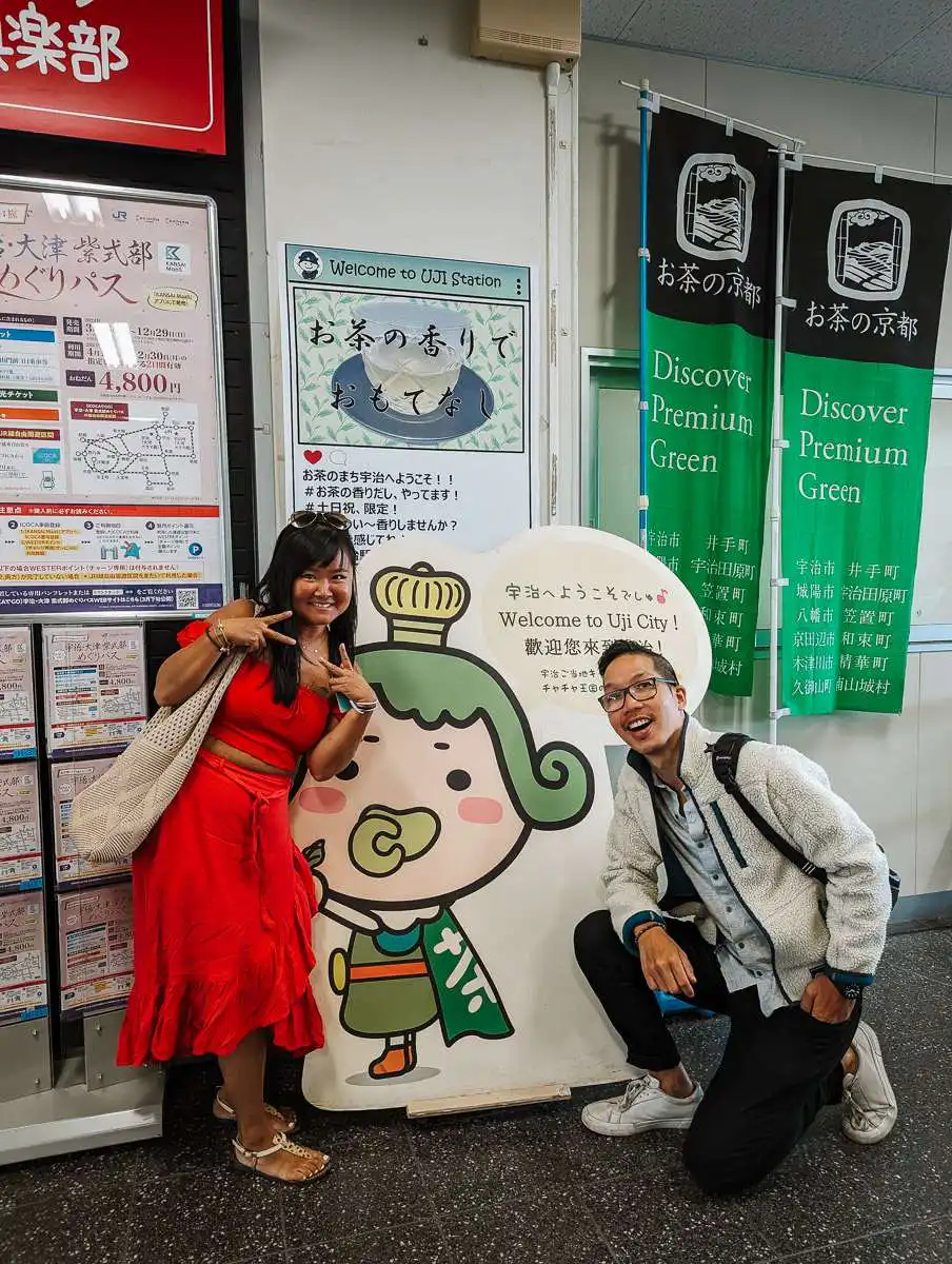 standing in front of Uji Japan mascot
