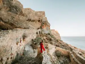 Woman sitting on the stairway up to upper town of Monemvasia