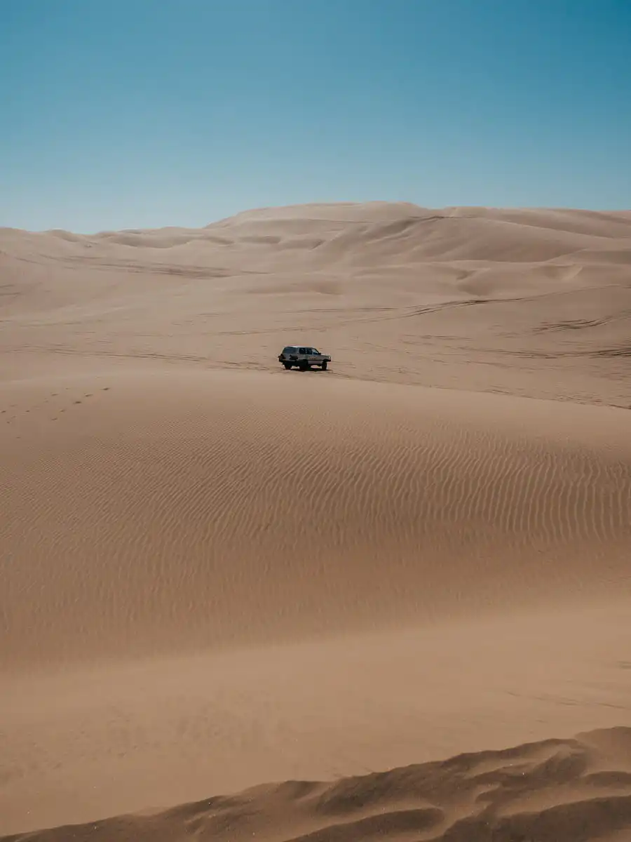 car in the sand dunes of sandwich harbour