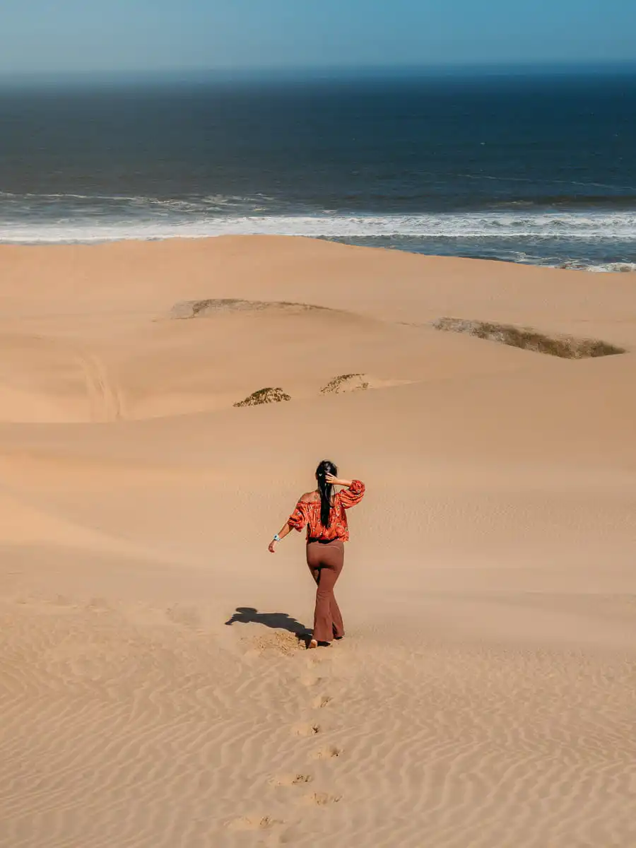 woman standing on the dunes of sandwich harbour