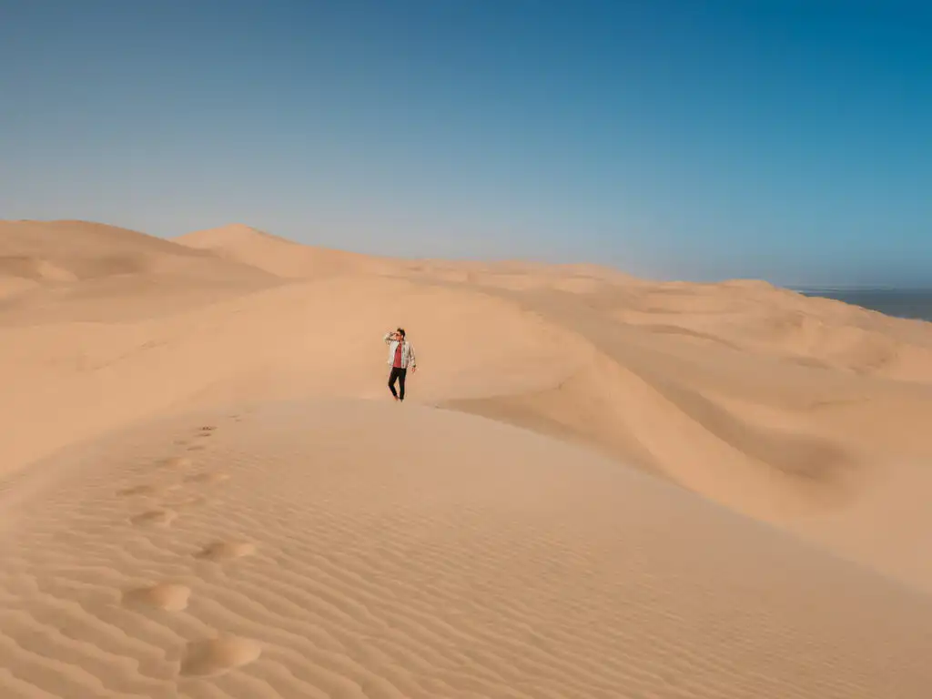 man standing on the dunes in sandwich harbour