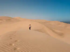 man standing on the dunes in sandwich harbour
