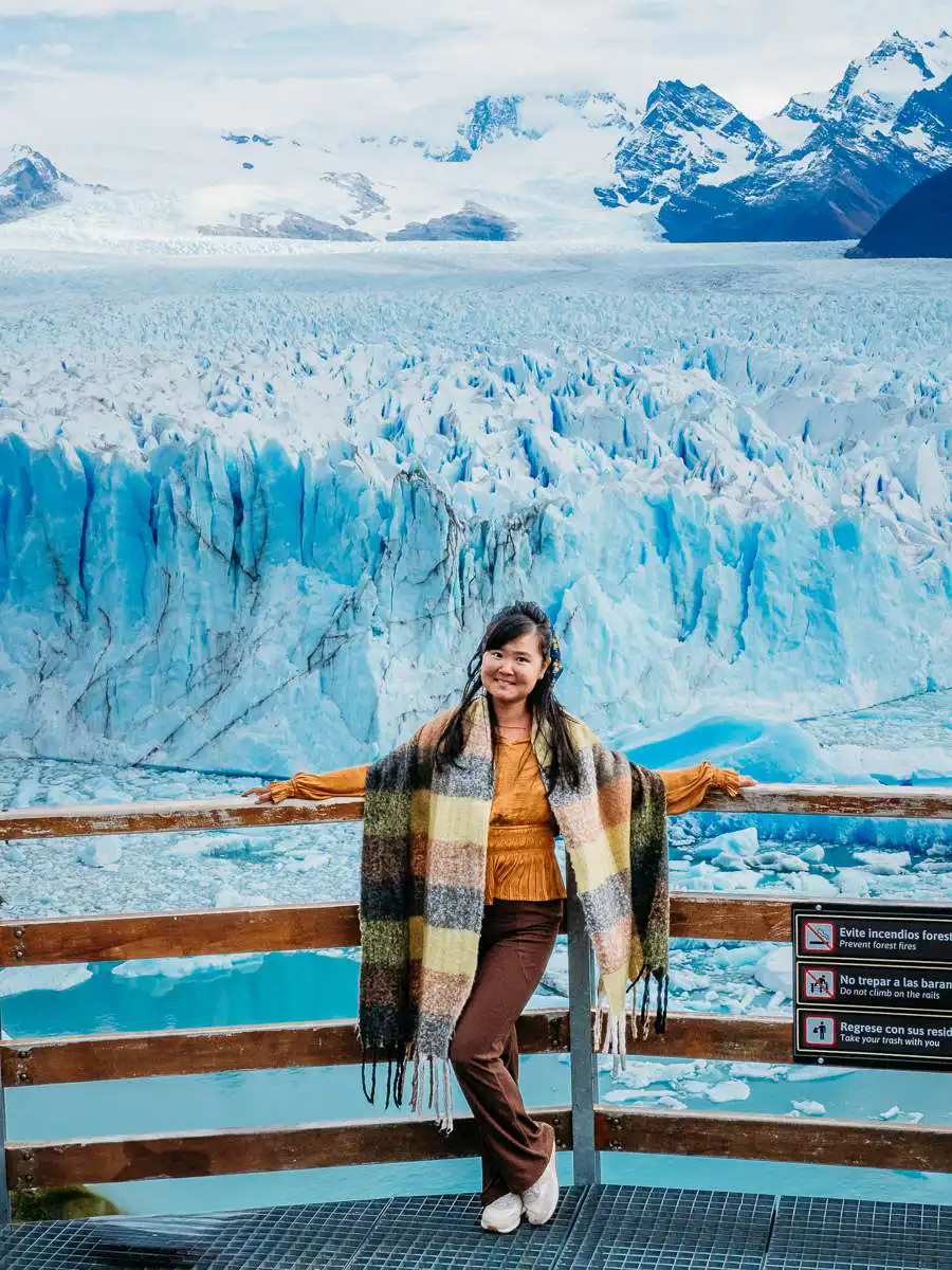 woman standing in front of perito moreno glacier
