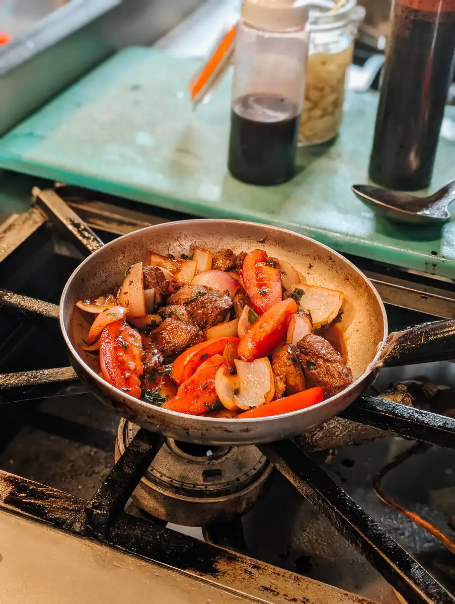 lomo saltado dish preparing during cooking class