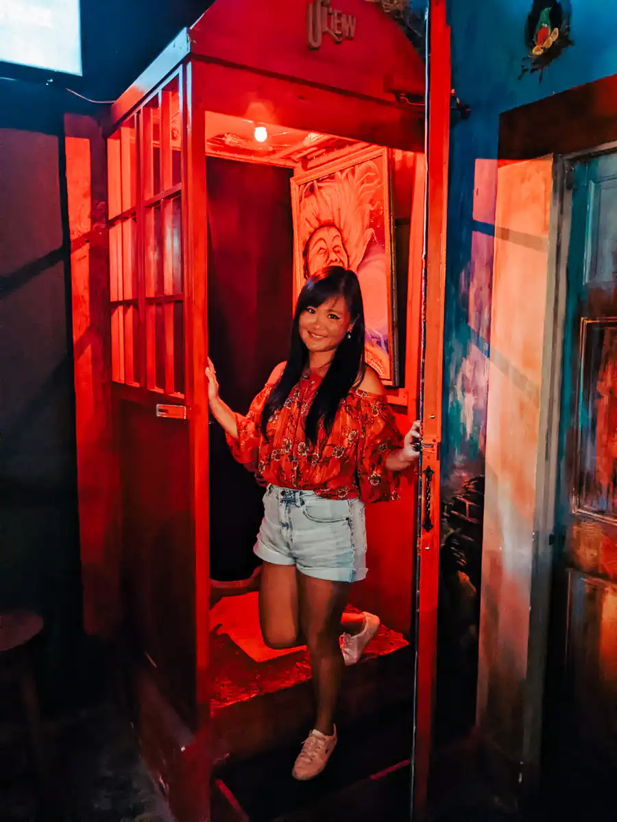 secret hidden speakeasy bar in antigua guatemala, walking through red phone booth