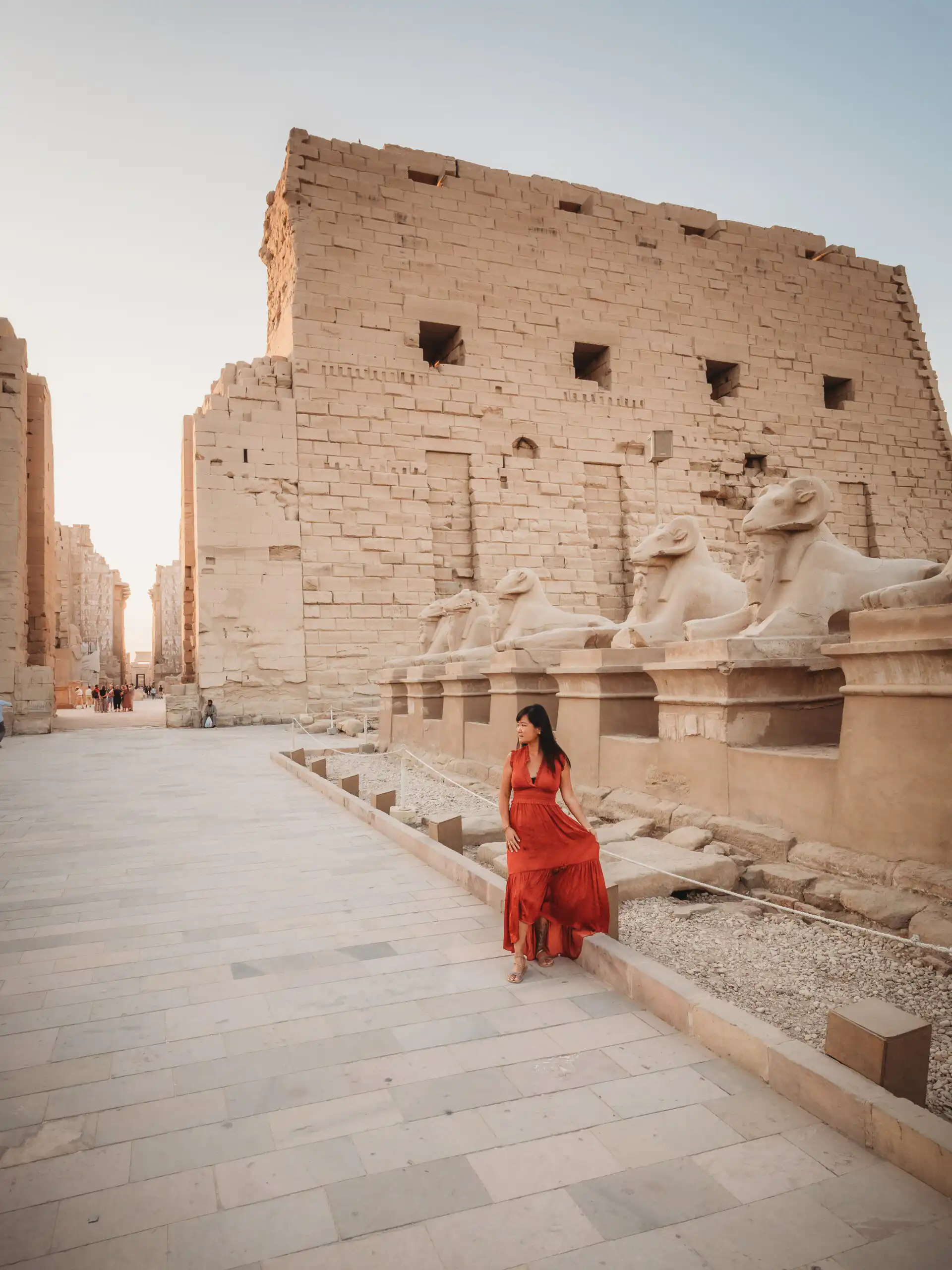woman standing at entrance of luxor temple