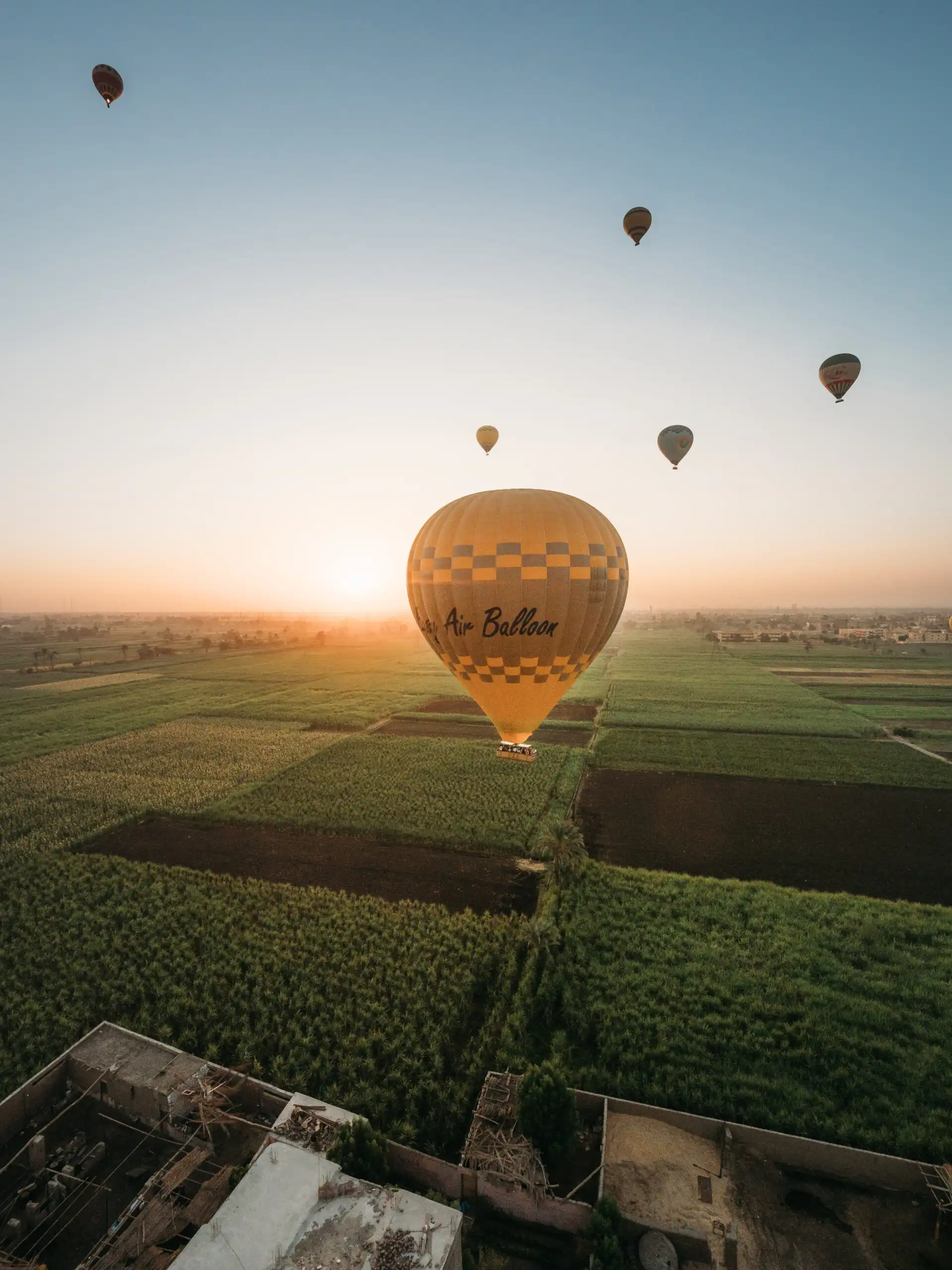 hot air balloon in front of sunrise in luxor