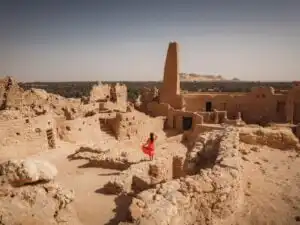 standing at the temple of the oracle in siwa oasis