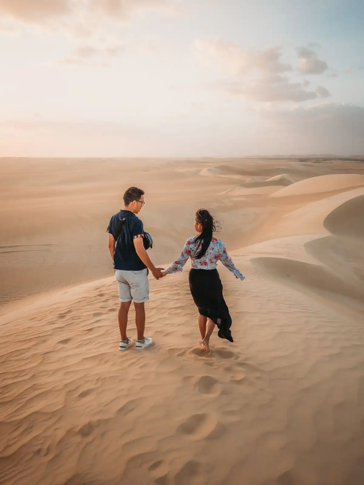 couple standing on the sand dunes of siwa