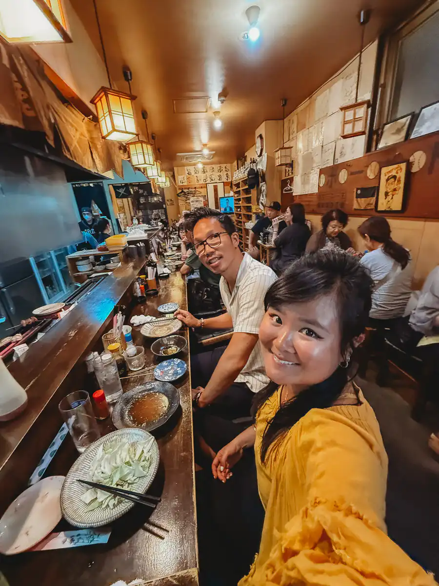 us sitting at the yakitori restaurant in fukuoka