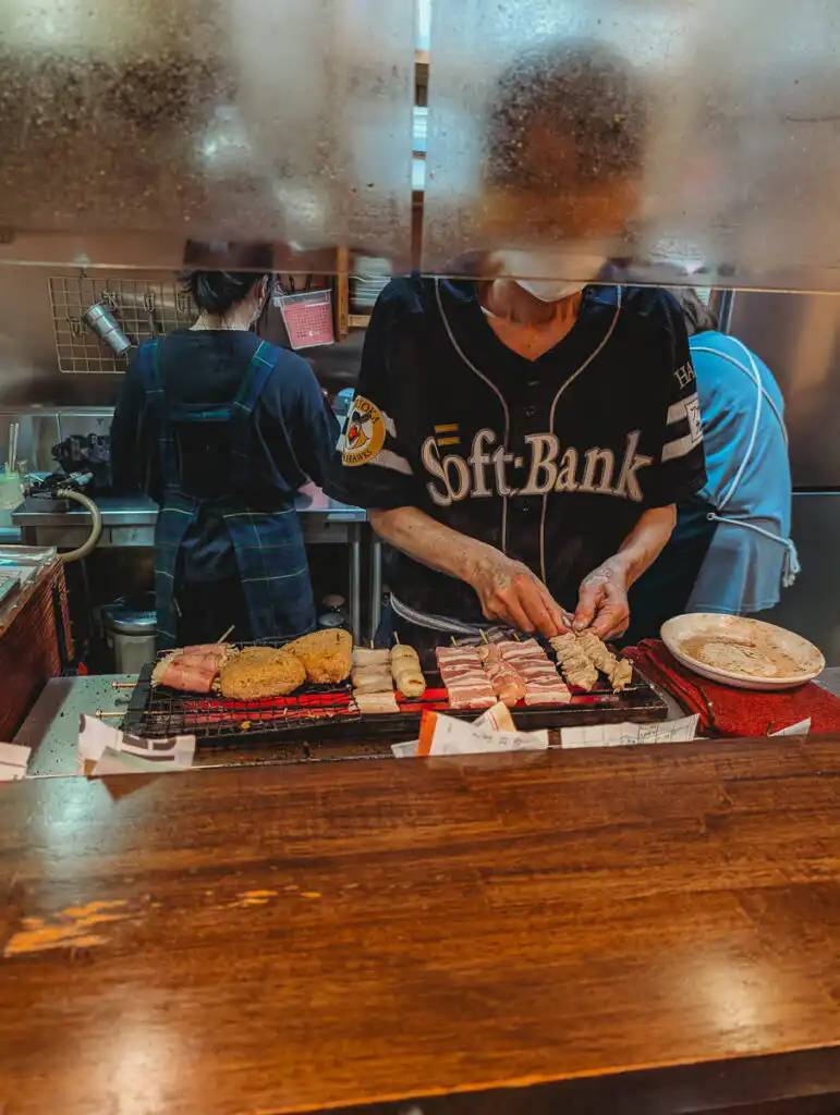 owner cooking skewers at restaurant