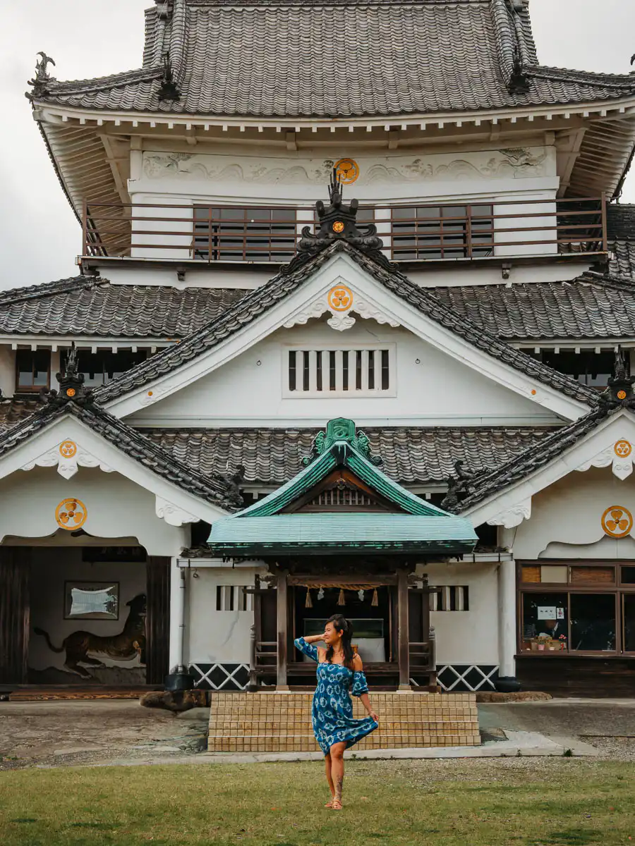 standing in front of kifune castle in Beppu