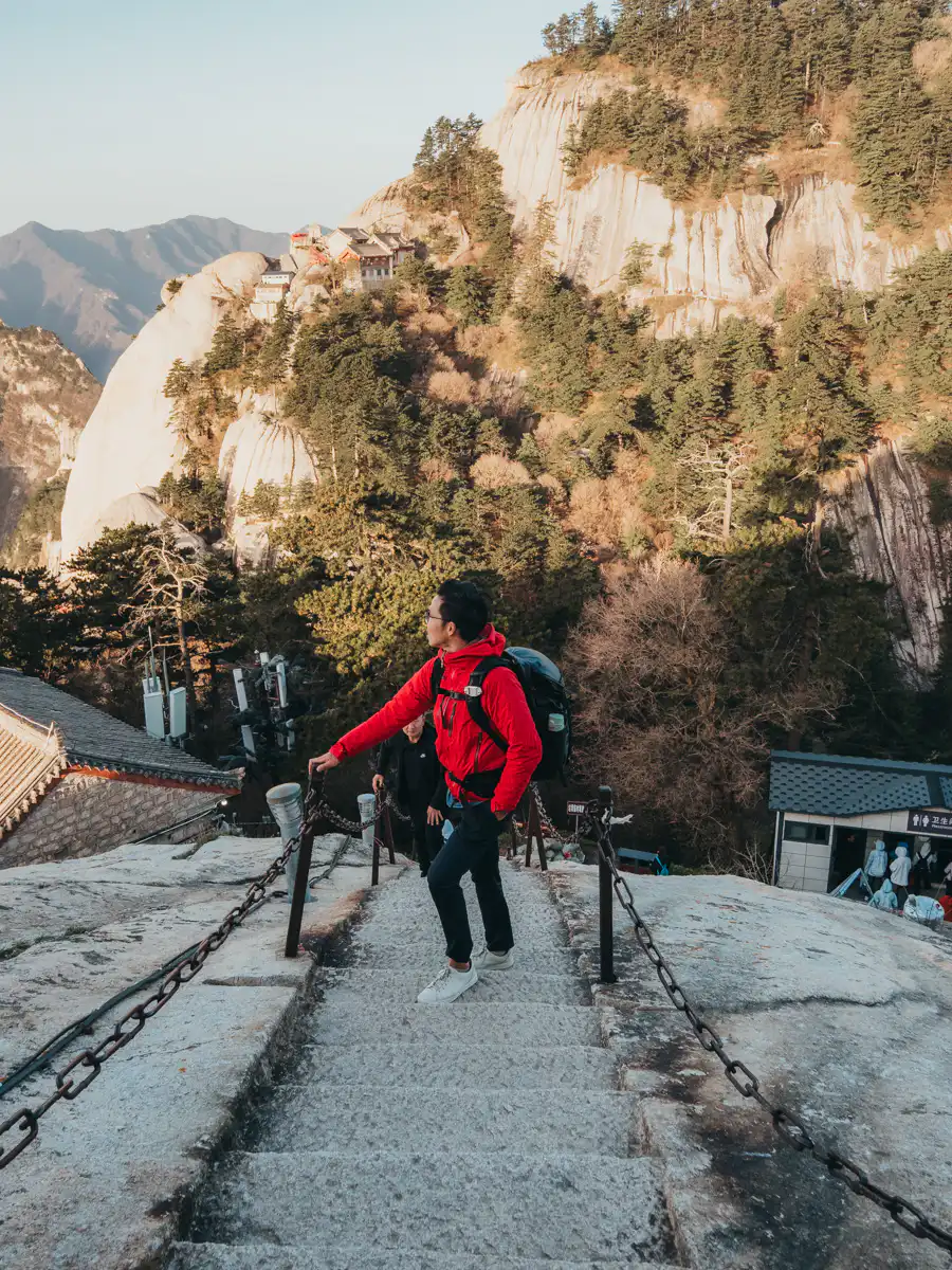 man standing on the staircase in hua shan