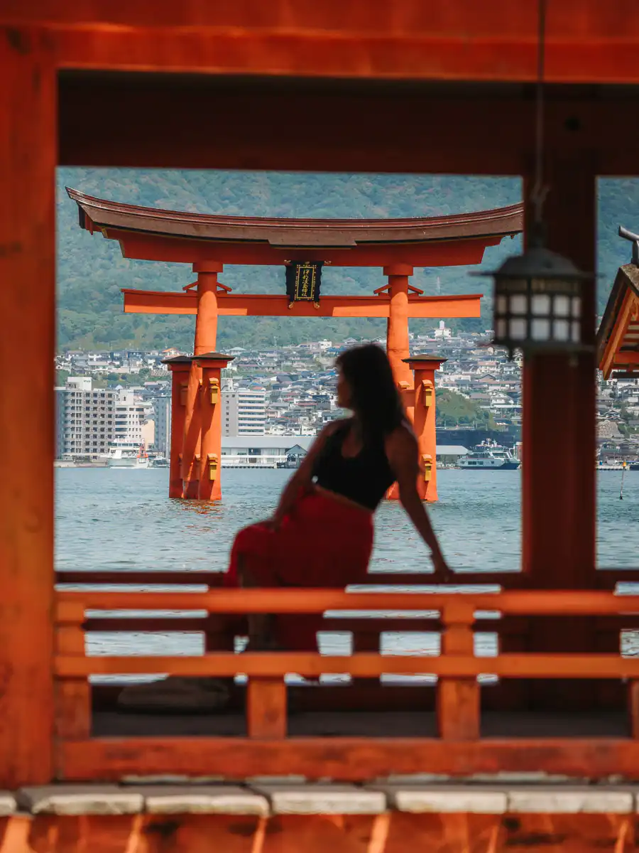 woman silhouette in front of tori gate of Miyajima