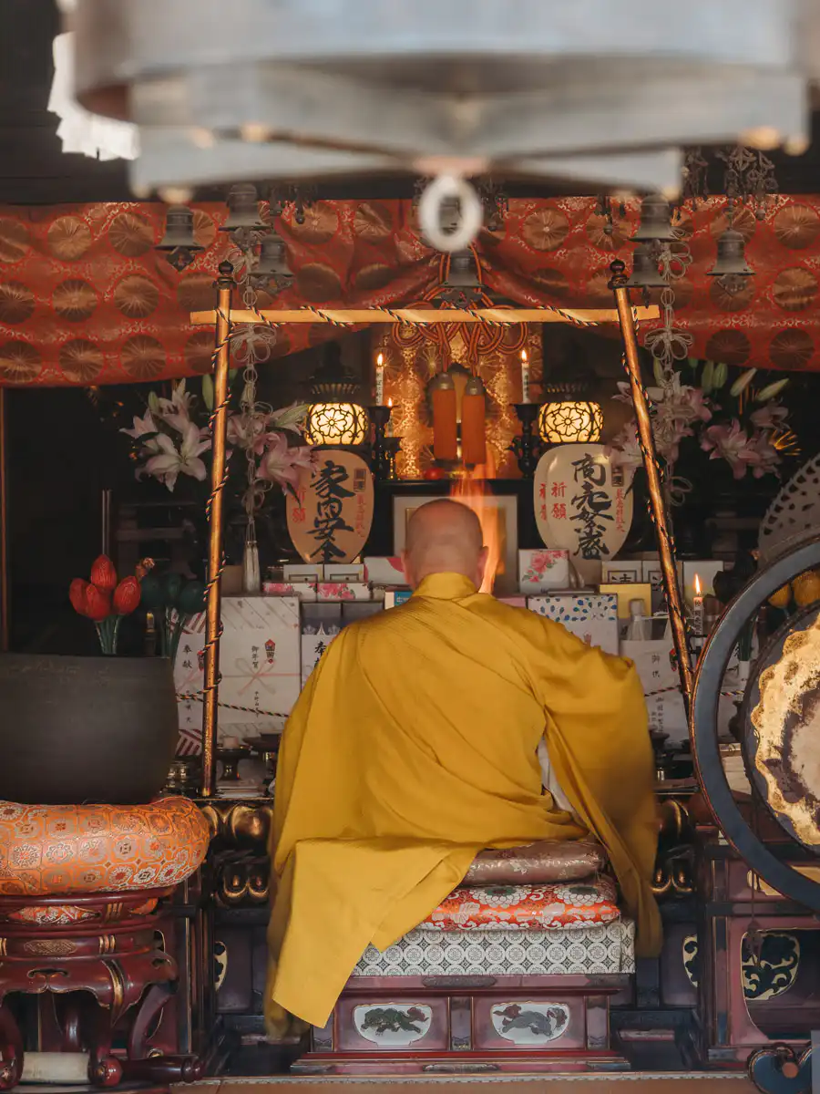 monk praying at Miyajima temple