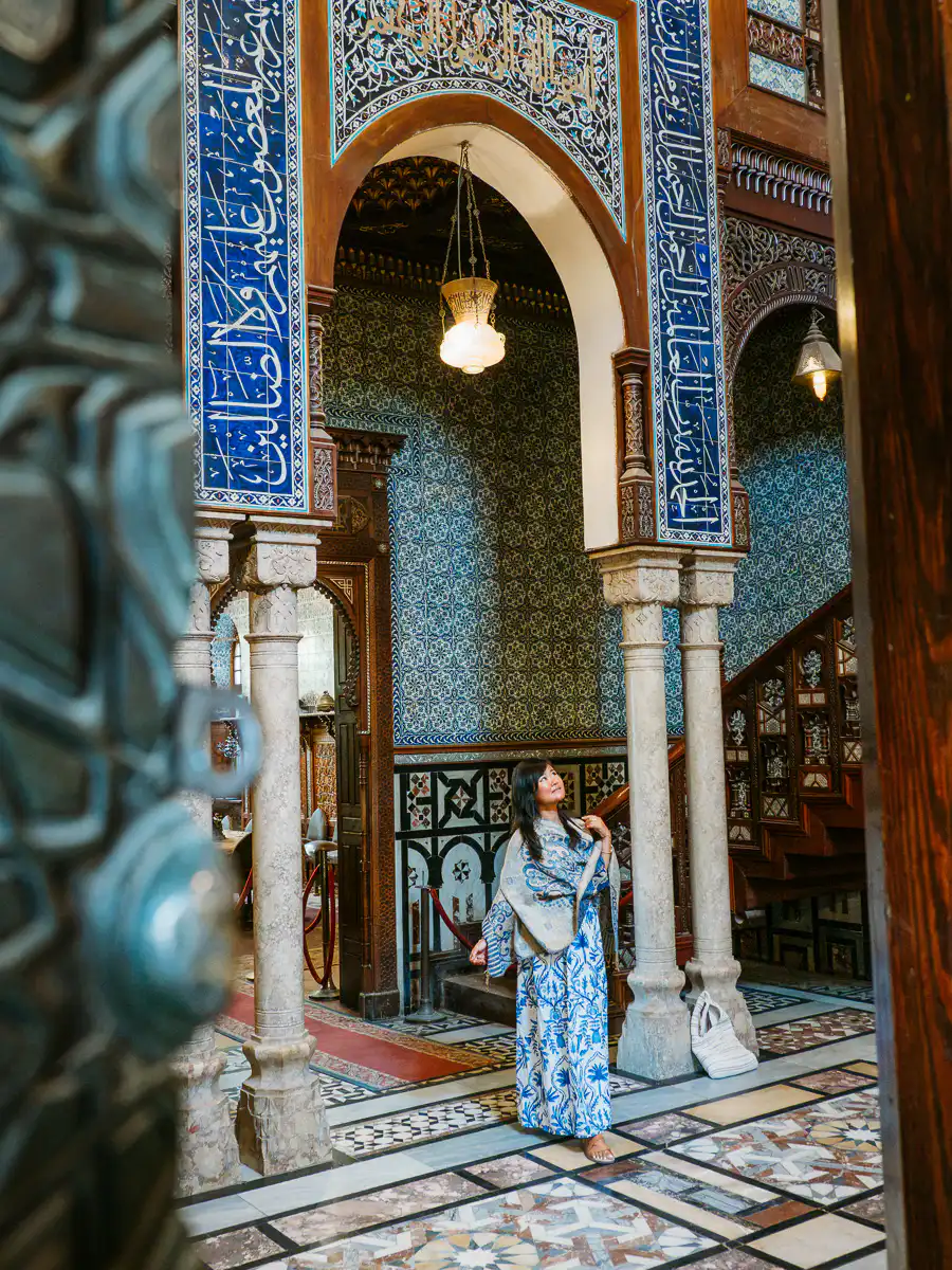 woman standing inside the palace of mohamed ali